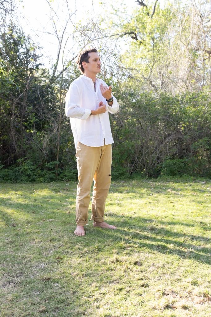 Nick Dearman standing outdoors in a mindful breath practice